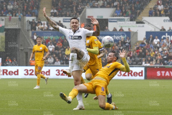 110818 - Swansea City v Preston North End, EFL Championship - Barrie McKay of Swansea City (left) is brought down by Alan Browne of Preston North End for a penalty