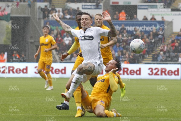 110818 - Swansea City v Preston North End, EFL Championship - Barrie McKay of Swansea City (left) is brought down by Alan Browne of Preston North End for a penalty