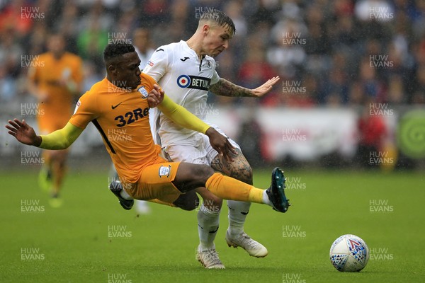 110818 - Swansea City v Preston North End, EFL Championship - Barrie McKay of Swansea City (right) is brought down by Darnell Fisher of Preston North End