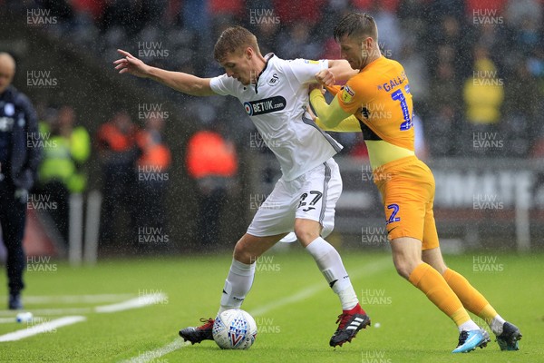 110818 - Swansea City v Preston North End, EFL Championship - Jay Fulton of Swansea City (left) shields the ball from Paul Gallagher of Preston North End