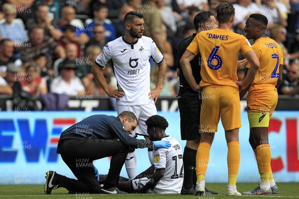 170819 - Swansea City v Preston North End, Sky Bet Championship - Nathan Dyer of Swansea City (seated) receives treatment after sustaining an injury