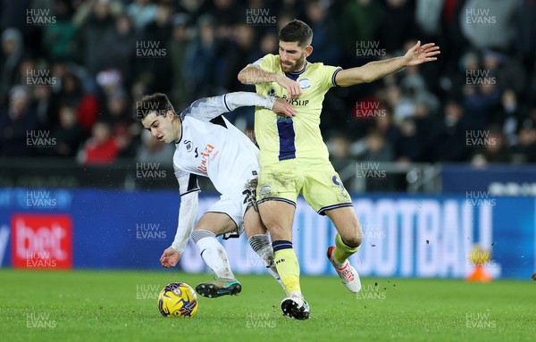 221223 - Swansea City v Preston North End - SkyBet Championship - Liam Walsh of Swansea City is tackled by Ched Evans of Preston North End 