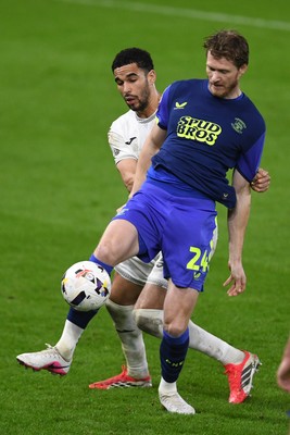 240226 - Swansea City v Preston North End - Sky Bet Championship - Ben Cabango of Swansea City is challenged by Michael Smith of Preston