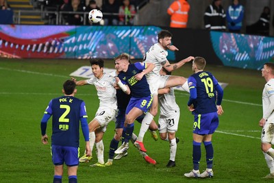 240226 - Swansea City v Preston North End - Sky Bet Championship - Cameron Burgess of Swansea City heads the ball away