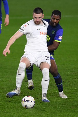 240226 - Swansea City v Preston North End - Sky Bet Championship - Zan Vipotnik of Swansea City is challenged by Andrew Hughes of Preston