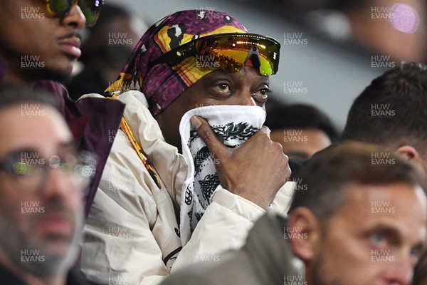 240226 - Swansea City v Preston North End - Sky Bet Championship - Snoop Dogg watches the game while covering his face after Preston score the opening goal