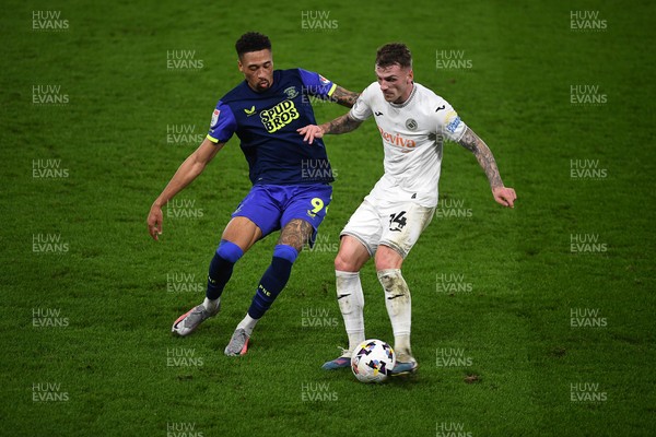 240226 - Swansea City v Preston North End - Sky Bet Championship - Josh Tymon of Swansea City is challenged by Daniel Jebbison of Preston