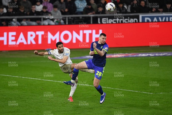 240226 - Swansea City v Preston North End - Sky Bet Championship - Ben Cabango of Swansea City is challenged by Milutin Osmajic