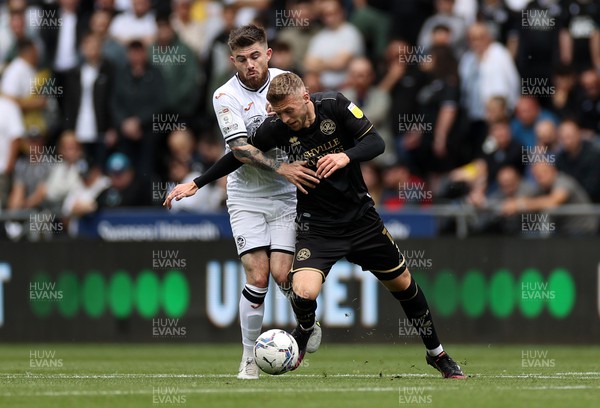 070522 - Swansea City v Queens Park Rangers - SkyBet Championship - Sam Field of QPR is tackled by Ryan Manning of Swansea City