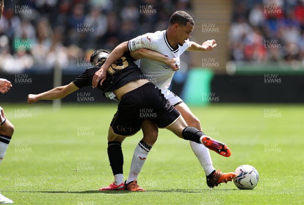070522 - Swansea City v Queens Park Rangers - SkyBet Championship - Joel Latibeaudiere of Swansea City is tackled by Ilias Chair of QPR