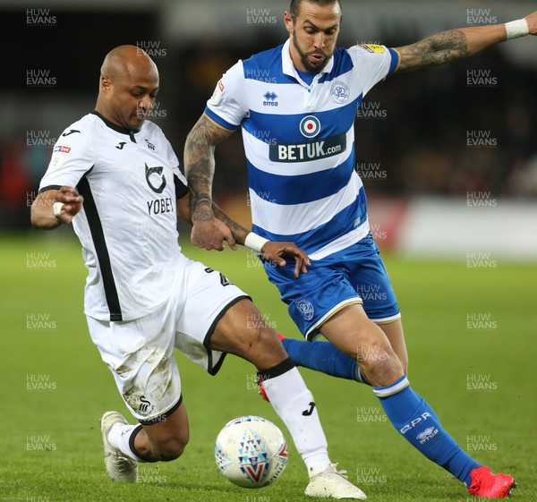 110220 - Swansea City v Queens Park Rangers, Sky Bet Championship - Andre Ayew of Swansea City holds off the challenge from Geoff Cameron of Queens Park Rangers