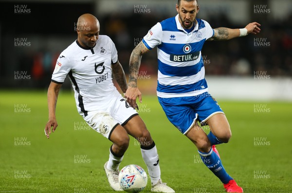 110220 - Swansea City v Queens Park Rangers, Sky Bet Championship - Andre Ayew of Swansea City holds off the challenge from Geoff Cameron of Queens Park Rangers