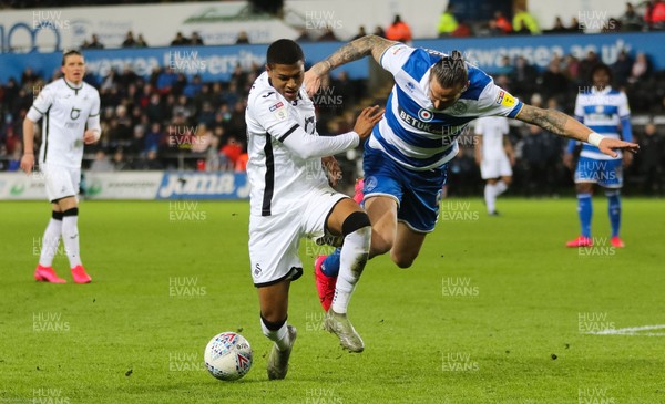 110220 - Swansea City v Queens Park Rangers, Sky Bet Championship - Rhian Brewster of Swansea City holds off the challenge from Geoff Cameron of Queens Park Rangers