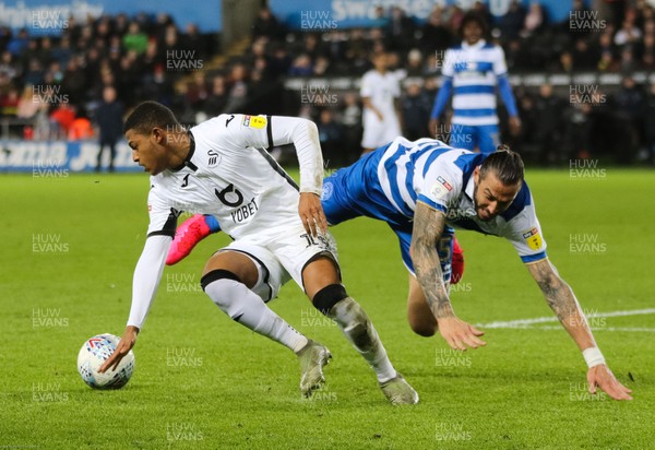 110220 - Swansea City v Queens Park Rangers, Sky Bet Championship - Rhian Brewster of Swansea City holds off the challenge from Geoff Cameron of Queens Park Rangers