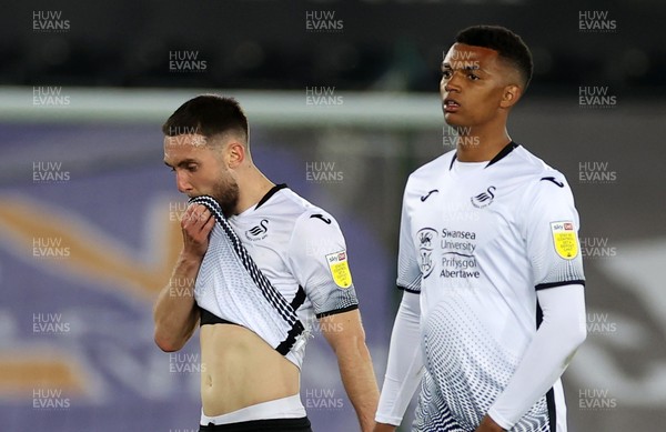 200421 - Swansea City v Queens Park Rangers - SkyBet Championship - Dejected Matt Grimes and Morgan Whittaker of Swansea City at full time