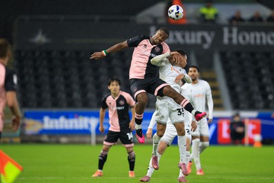 221025 - Swansea City v Queens Park Rangers - Sky Bet Championship - Ronald of Swansea City challenges for the aerial ball with Richard Kone of Queens Park Rangers
