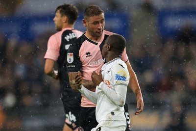 221025 - Swansea City v Queens Park Rangers - Sky Bet Championship -  Malick Yalcouye of Swansea City clashes with Steve Cook of Queens Park Rangers