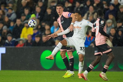 221025 - Swansea City v Queens Park Rangers - Sky Bet Championship - Adam Idah of Swansea City  battles for the ball with Jimmy Dunne of Queens Park Rangers