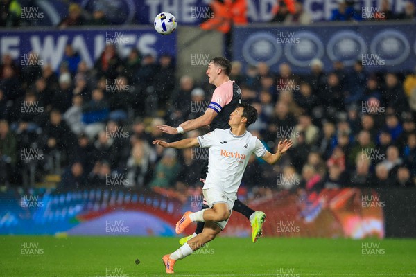 221025 - Swansea City v Queens Park Rangers - Sky Bet Championship - Jimmy Dunne of Queens Park Rangers challenges for the aerial ball with Eom Ji-Sung of Swansea City