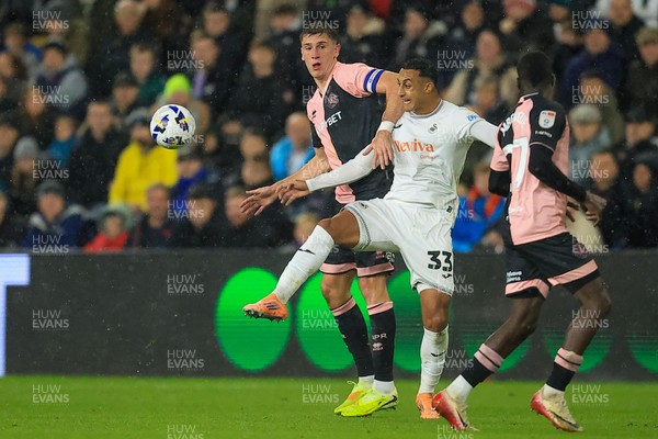 221025 - Swansea City v Queens Park Rangers - Sky Bet Championship - Adam Idah of Swansea City  battles for the ball with Jimmy Dunne of Queens Park Rangers