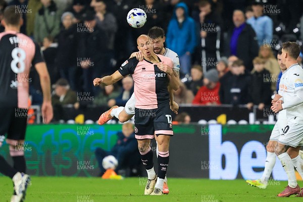 221025 - Swansea City v Queens Park Rangers - Sky Bet Championship - Michael Frey of Queens Park Rangers battles for the ball with Cameron Burgess of Swansea City
