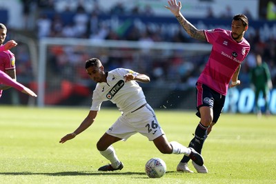 290918 - Swansea City v Queens Park Rangers - SkyBet Championship - Kyle Naughton of Swansea City is tackled by Geoff Cameron of Queens Park Rangers