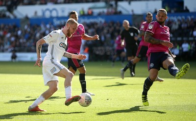 290918 - Swansea City v Queens Park Rangers - SkyBet Championship - Oli McBurnie of Swansea City is challenged by Joel Lynch of Queens Park Rangers