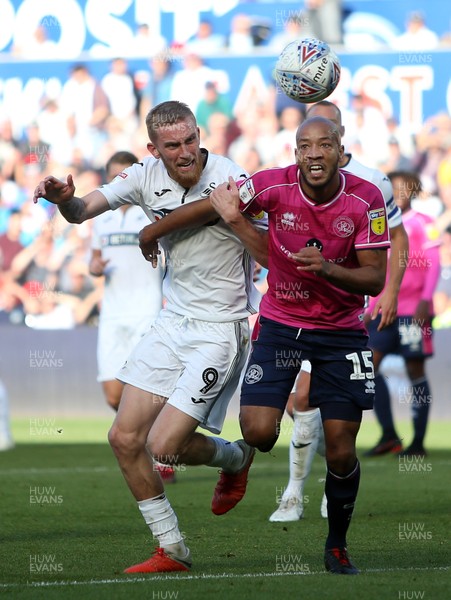 290918 - Swansea City v Queens Park Rangers - SkyBet Championship - Alex John-Baptiste of Queens Park Rangers is challenged by Oli McBurnie of Swansea City