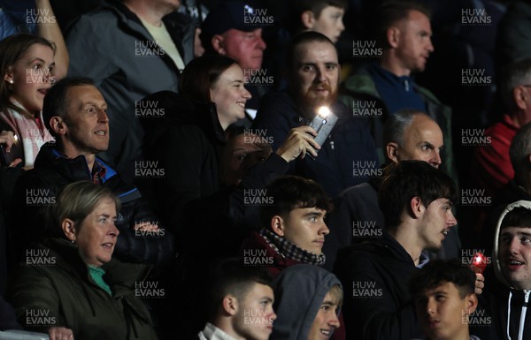 181022 - Swansea City v Reading - SkyBet Championship - Fans hold phone torches up as the flood lights cut out