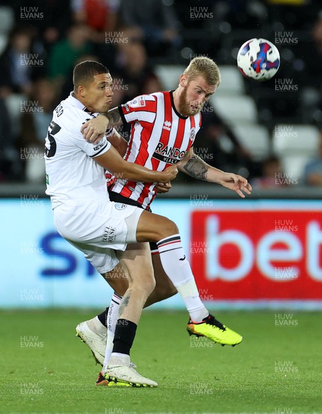 130922 - Swansea City v Sheffield United - SkyBet Championship - Nathan Wood of Swansea City is challenged by Oliver McBurnie of Sheffield United