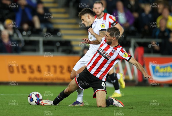 130922 - Swansea City v Sheffield United - SkyBet Championship - Jamie Paterson of Swansea City is tackled by Chris Basham of Sheffield United