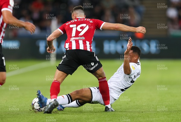 140821 - Swansea City v Sheffield United, EFL Sky Bet Championship - Joel Latibeaudiere of Swansea City is brought down by Jack Robinson of Sheffield United