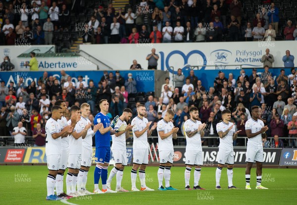 140821 - Swansea City v Sheffield United, EFL Sky Bet Championship - Swansea City team mark a minutes applause at the start of the match in memory of fans who died during the COVID pandemic and to thank NHS staff