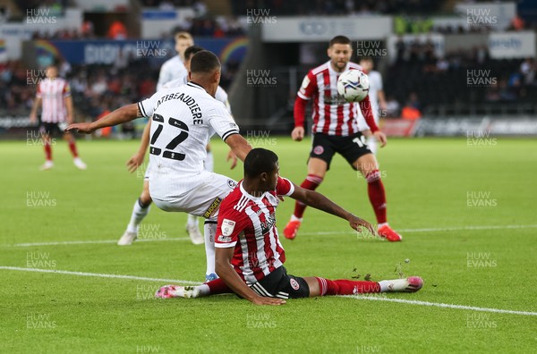 140821 - Swansea City v Sheffield United, EFL Sky Bet Championship - Joel Latibeaudiere of Swansea City and Rhian Brewster of Sheffield United compete for the ball