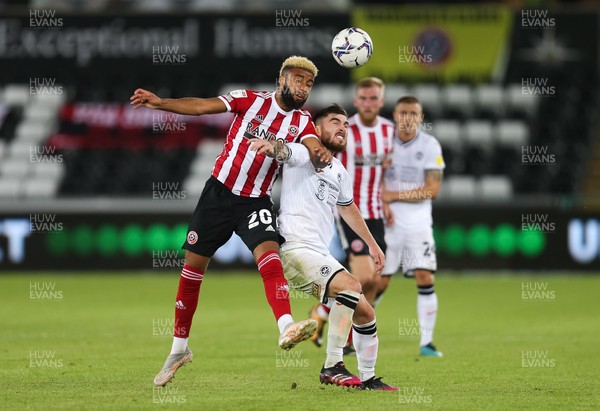 140821 - Swansea City v Sheffield United, EFL Sky Bet Championship - Jayden Bogle of Sheffield United and Ryan Manning of Swansea City tangle as they compete for the ball
