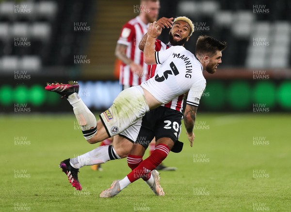 140821 - Swansea City v Sheffield United, EFL Sky Bet Championship - Jayden Bogle of Sheffield United and Ryan Manning of Swansea City tangle as they compete for the ball