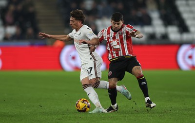 210125  Swansea City v Sheffield United, EFL Sky Bet Championship - Goncalo Franco of Swansea City is challenged by Gustavo Hamer of Sheffield United