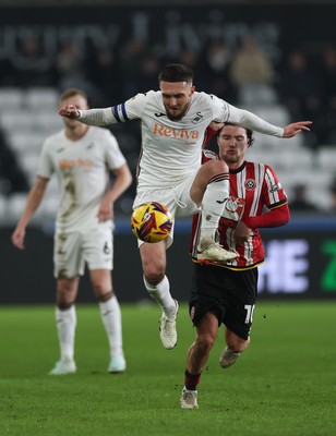 210125  Swansea City v Sheffield United, EFL Sky Bet Championship - Matt Grimes of Swansea City wins the ball from Callum O'Hare of Sheffield United