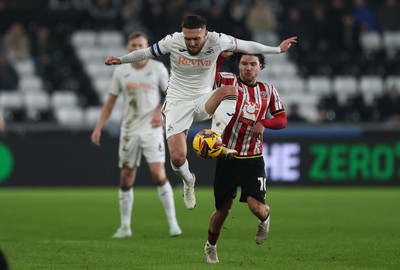 210125  Swansea City v Sheffield United, EFL Sky Bet Championship - Matt Grimes of Swansea City wins the ball from Callum O'Hare of Sheffield United