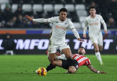 210125  Swansea City v Sheffield United, EFL Sky Bet Championship - Myles Peart-Harris of Swansea City is tackled by Gustavo Hamer of Sheffield United