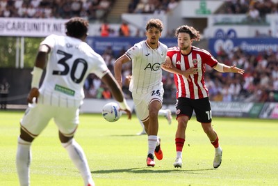 220826 - Swansea City v Sheffield United - Sky Bet Championship - Filip Lissah of Swansea City passes the ball away from Callum O'Hare of Sheffield United 