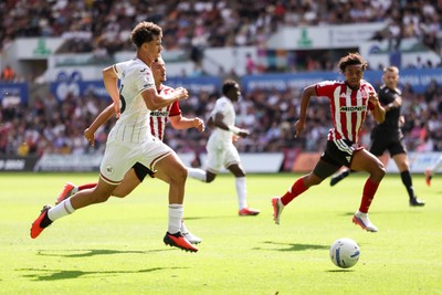 220826 - Swansea City v Sheffield United - Sky Bet Championship - Filip Lissah of Swansea City attacks with pressure from Harrison Burrows of Sheffield United 