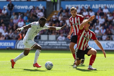 220826 - Swansea City v Sheffield United - Sky Bet Championship - Joseph Opoku of Swansea City takes on Harrison Burrows of Sheffield United 