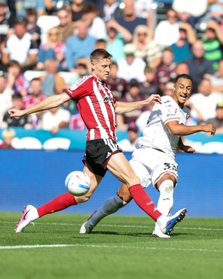 220826 - Swansea City v Sheffield United - Sky Bet Championship - Adam Idah of Swansea City passes the ball past Mark McGuinness of Sheffield United 