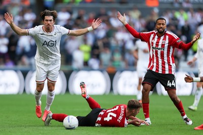220826 - Swansea City v Sheffield United - Sky Bet Championship - Jaïro Riedewald of Sheffield United (R) and Josh Key of Swansea City react to a foul on Harrison Burrows of Sheffield United (C) 