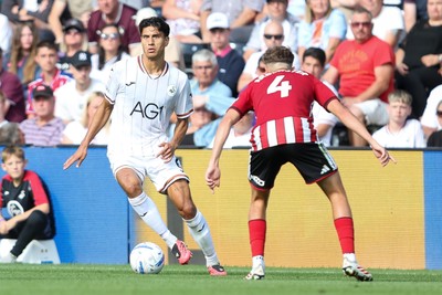 220826 - Swansea City v Sheffield United - Sky Bet Championship - Marko Stamenic of Swansea City takes on Oliver Arblaster of Sheffield United 