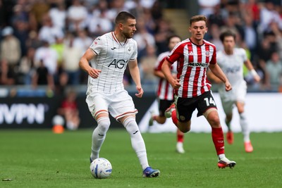220826 - Swansea City v Sheffield United - Sky Bet Championship - Zan Vipotnik of Swansea City attacks with pressure from Harrison Burrows of Sheffield United 