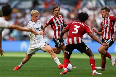 220826 - Swansea City v Sheffield United - Sky Bet Championship - Melker Widell of Swansea City takes on Sam McCallum (C) and Oliver Arblaster of Sheffield United (R) 