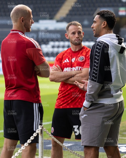 220826 - Swansea City v Sheffield United - Sky Bet Championship - Adam Davies (L) Rhys Norrington-Davies (C) Ben Cabango of Swansea City (R) have a catch up