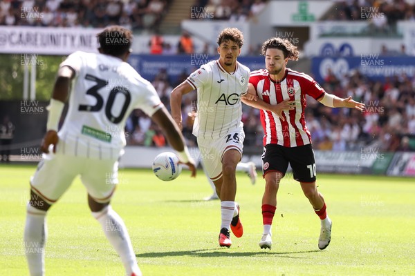 220826 - Swansea City v Sheffield United - Sky Bet Championship - Filip Lissah of Swansea City passes the ball away from Callum O'Hare of Sheffield United 